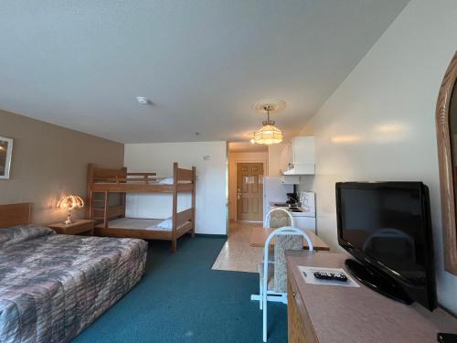 怀特考特Western Budget Motel #3 Whitecourt的配有一张床和一台平面电视的酒店客房