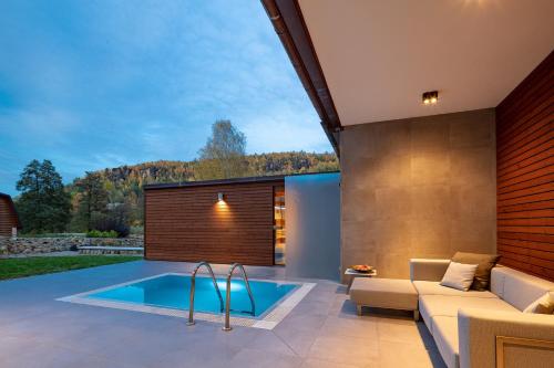蒂萨奥斯特鲁夫皮特劳恩酒店的一个带沙发和沙发的庭院内的游泳池