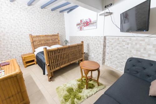 Anse-BertrandLe Domharry的一间带床和电视的小卧室