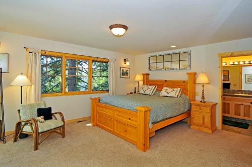 奥林匹克谷Sierra Crest at Palisades Tahoe - Secluded Luxury 5BR 5 BA w Wood Fireplace的一间卧室配有一张床和一把椅子