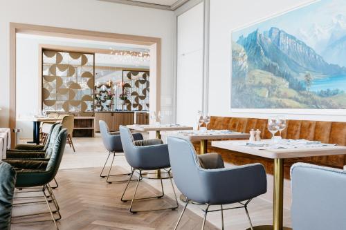 梅尔里根贝尔多斯康体SPA酒店的一间带桌椅的餐厅,以及一幅大画