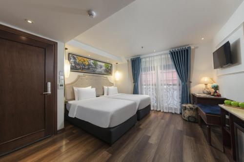 河内Hanoi Calista Hotel的卧室配有一张白色大床和一张书桌