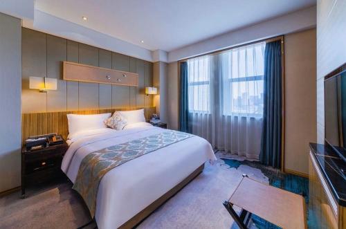 银川银川西府井饭店的酒店客房设有一张大床和一台电视。