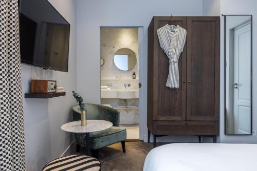 阿姆斯特丹Maison ELLE Amsterdam的一间卧室配有一张床、一张桌子和一面镜子