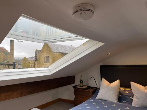 海伯敦桥Bonsalls Central Hebden Bridge的一间卧室设有一张床和一个大窗户