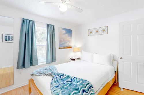 德斯坦St Martin Beachwalk Villas 212的一间卧室配有白色的床和蓝色窗帘