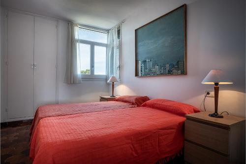 托里代巴拉AT013 Torremunts的一间卧室设有红色的床和大窗户
