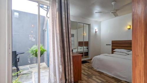 乌库拉斯Coco Villa Ukulhas的一间卧室设有一张床和一个大窗户
