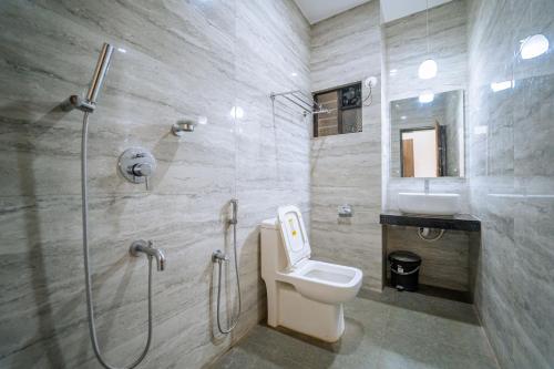 阿贡达Darsy Residency的带淋浴、卫生间和盥洗盆的浴室