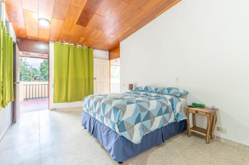 圣萨尔瓦多Volcano Hostal y Restaurante的一间卧室设有一张床和木制天花板