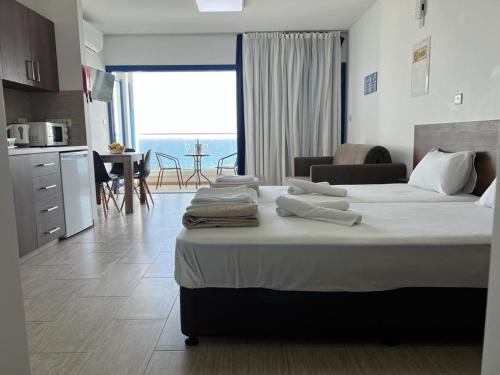 总督海滩Governors Beach Panayiotis的一间带两张床的卧室和一间享有美景的厨房