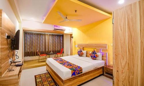 KhandagiriFabHotel Sai Jagannath Residency的一间卧室配有一张床和一台电视