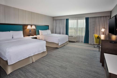 尤宁城Hampton Inn Union City, Tn的酒店客房设有两张床和电视。