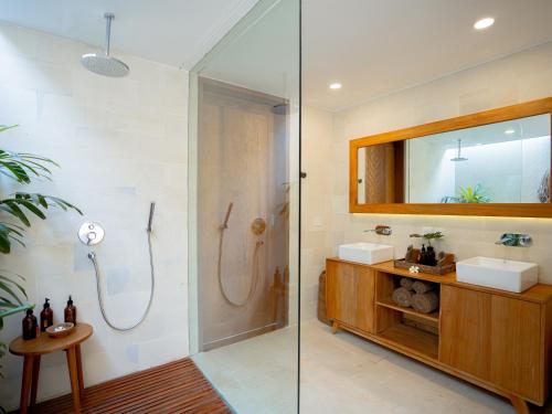 吉利特拉旺安Cocana Resort Gili Trawangan的带淋浴、盥洗盆和镜子的浴室