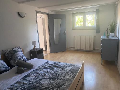 科尔讷巴里厄Appartement a Cornebarrieu的一间卧室设有一张大床和一个窗户。