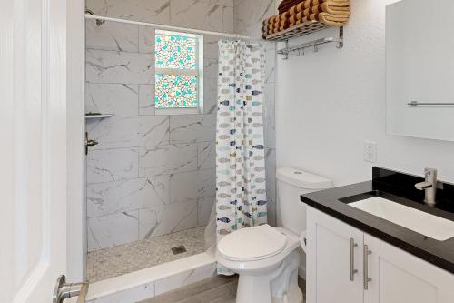 马拉松Sea Grape Getaway的白色的浴室设有卫生间和淋浴。