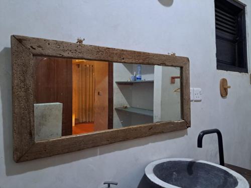 拉穆Pwani House - Lamu Seafront的浴室内水槽上方的镜子