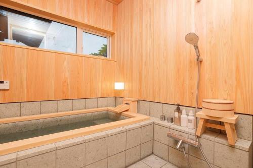 会津若松楽善堂Rakuzendo的带浴缸和窗户的浴室