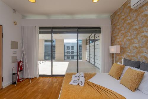 里斯本BeGuest Benfica Modern Flat的一间卧室,配有一张床,上面有两双鞋
