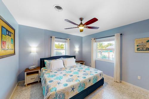 伊斯拉莫拉达Gemstone Isle的一间卧室配有一张床和吊扇
