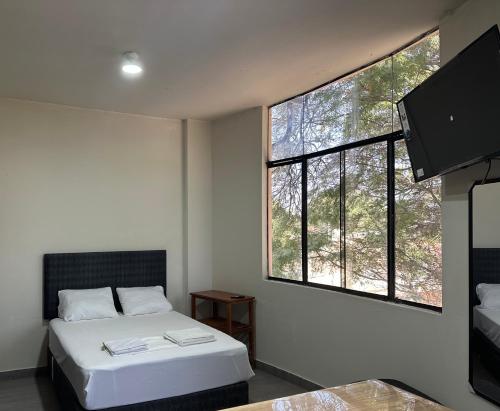 皮乌拉Casa Mimaya的一间卧室设有一张床和一个大窗户