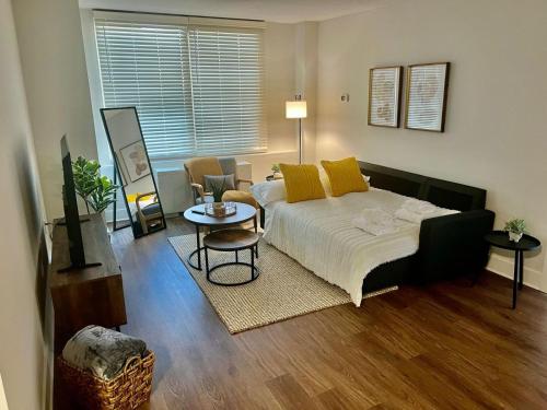 阿林顿Comfy Getaway by DC,Metro,Airport的一间卧室配有一张带黄色枕头和桌子的床