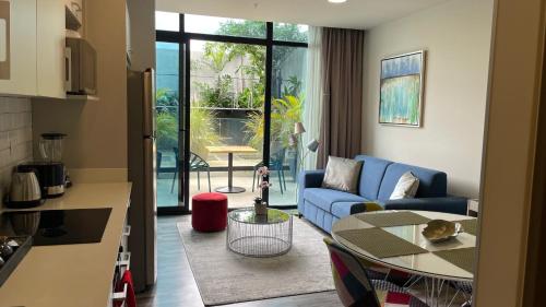 圣何塞Cozy apartment with terrace, SJ Cosmopolitan Tower的客厅配有蓝色的沙发和桌子