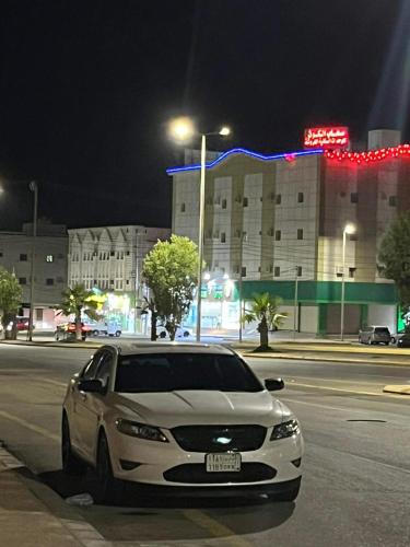 沃季赫شقه فاخره的夜间停在城市街道上的白色汽车
