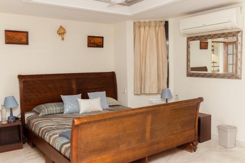 班加罗尔Luho 41 Penthouse的一间卧室配有一张带蓝色枕头的大型木制床。