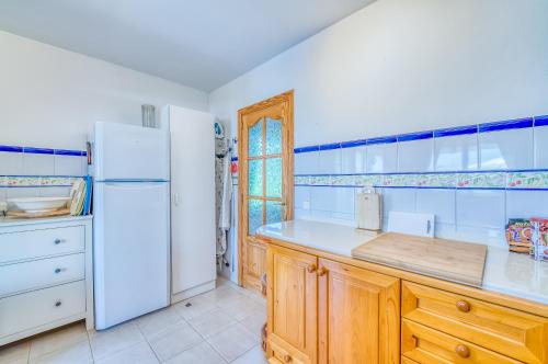阿尔库迪亚Casa Kerchner的厨房配有白色冰箱和木制橱柜。