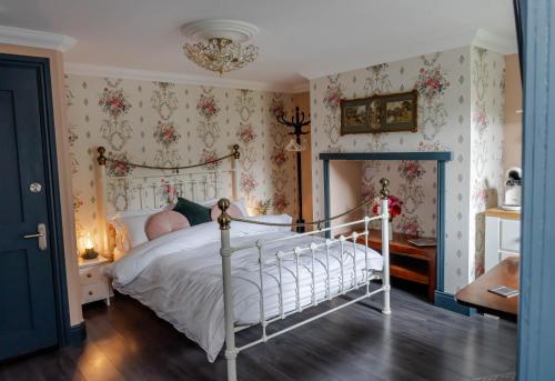 迪尔Anne Boleyn’s Escape的卧室配有白色床和花卉壁纸