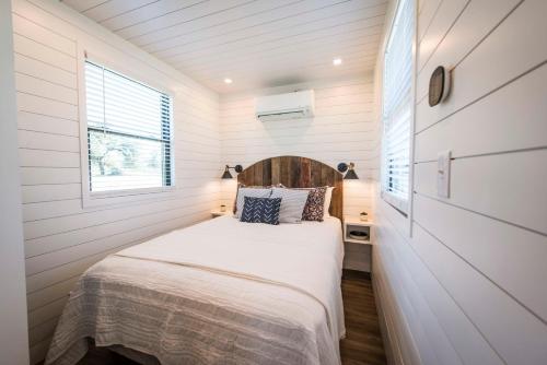 BellmeadThe Meadows Shipping Container Home的一间小房子里的卧室,配有床