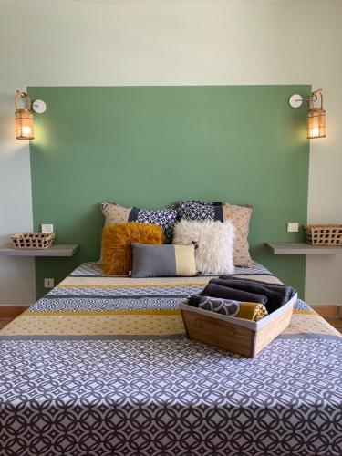 拉特里尼泰Sous les tropiques的一间卧室配有一张大床和枕头