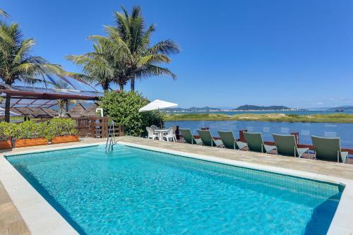 弗洛里亚诺波利斯哥斯达诺特彭塔卡纳斯酒店的一个带椅子的游泳池,享有水景
