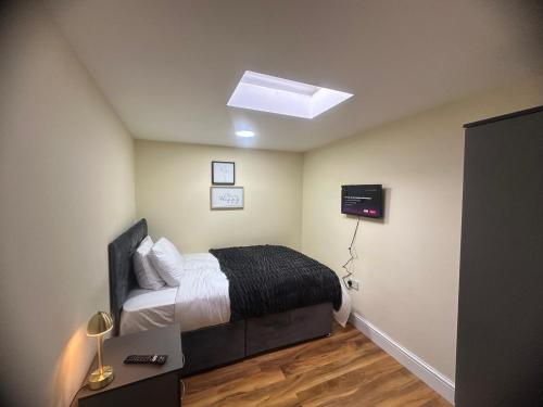 达格纳姆Experience Downing Road Dagenham 2 bedroom Apartment的一间卧室配有一张床和天窗