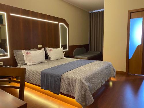 加亚新城Motel Paraíso do Braseiro的配有一张床和一把椅子的酒店客房
