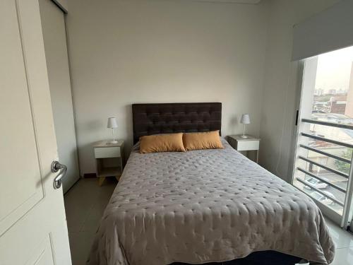 科连特斯Departamento céntrico con cochera - Corrientes Capital的一间卧室设有一张大床和一个窗户。