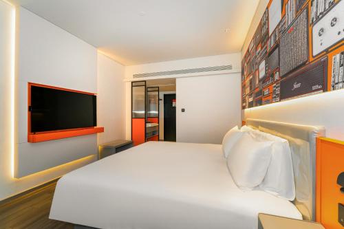 西安宜必思酒店(西安钟鼓楼回民街店- 广济街地铁站260米 ）的卧室配有白色的床和平面电视。