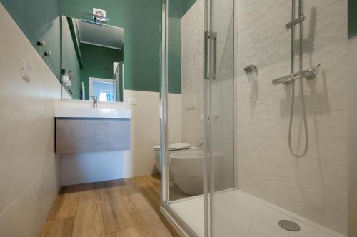 罗马泰尔米尼公寓的一间带玻璃淋浴和卫生间的浴室