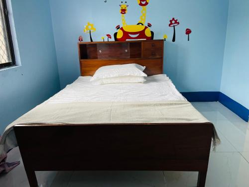 苏瓦Grace house的一张带木制床头板的床