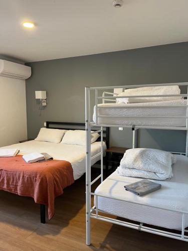 巴约讷Hostel 20 Bayonne的客房设有两张双层床和一张床。