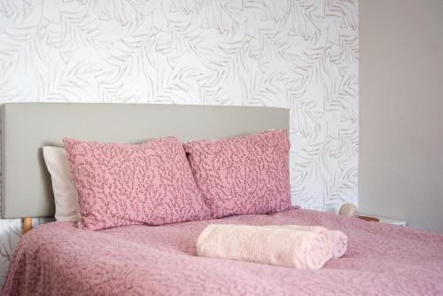 马拉加Carmen Estacion的粉红色的床、粉色毯子和枕头