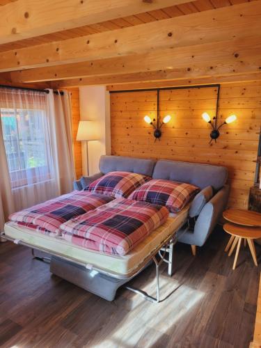 NeudorfChristinas Ferienhäuser in Rodewald的一间卧室设有一张床和木墙