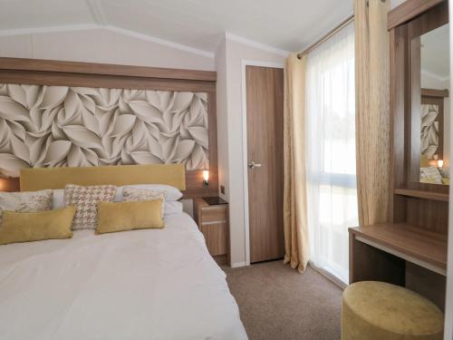 新米尔顿The Olive Lodge, 227 Sycamore的卧室设有一张白色大床和一扇窗户。