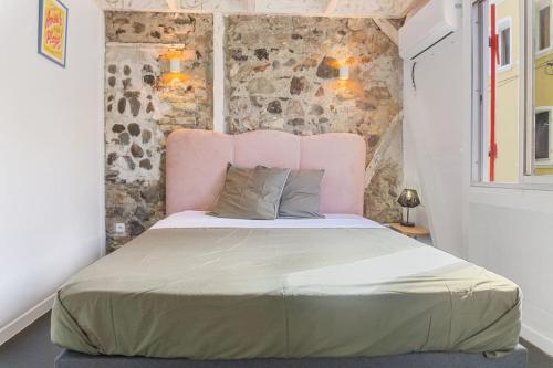 Saint-PierreMaison Bernabet - Rooftop avec vue sur la Montagne Pelée的一间卧室配有一张带粉红色床头板的大床