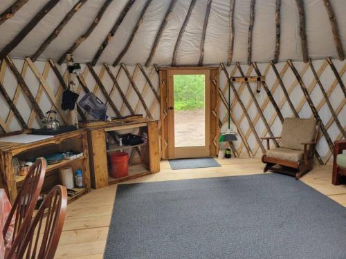 BrownfieldAva Jade Yurt的一间设有蒙古包、椅子和门的房间
