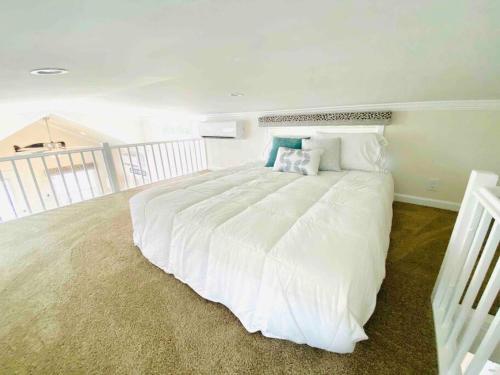 默特尔比奇Vacation Cottages in North Myrtle Beach 66的卧室配有带枕头的大型白色床