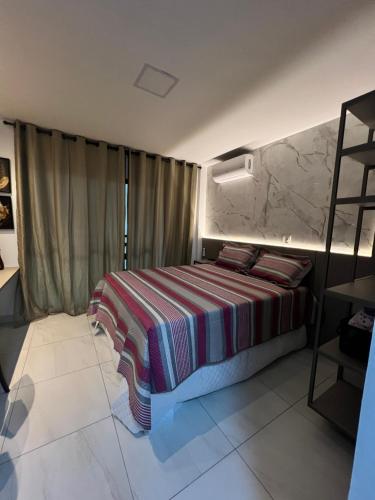 卡贝德卢Laguna Beach House的一间卧室配有带条纹毯子的床