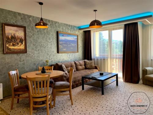 潘波洛沃Deluxe Apartment 33 Mountain Lodge Pamporovo的客厅配有沙发和桌子