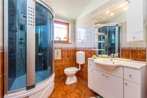 加利扎纳Villa Ninetta的带淋浴、卫生间和盥洗盆的浴室